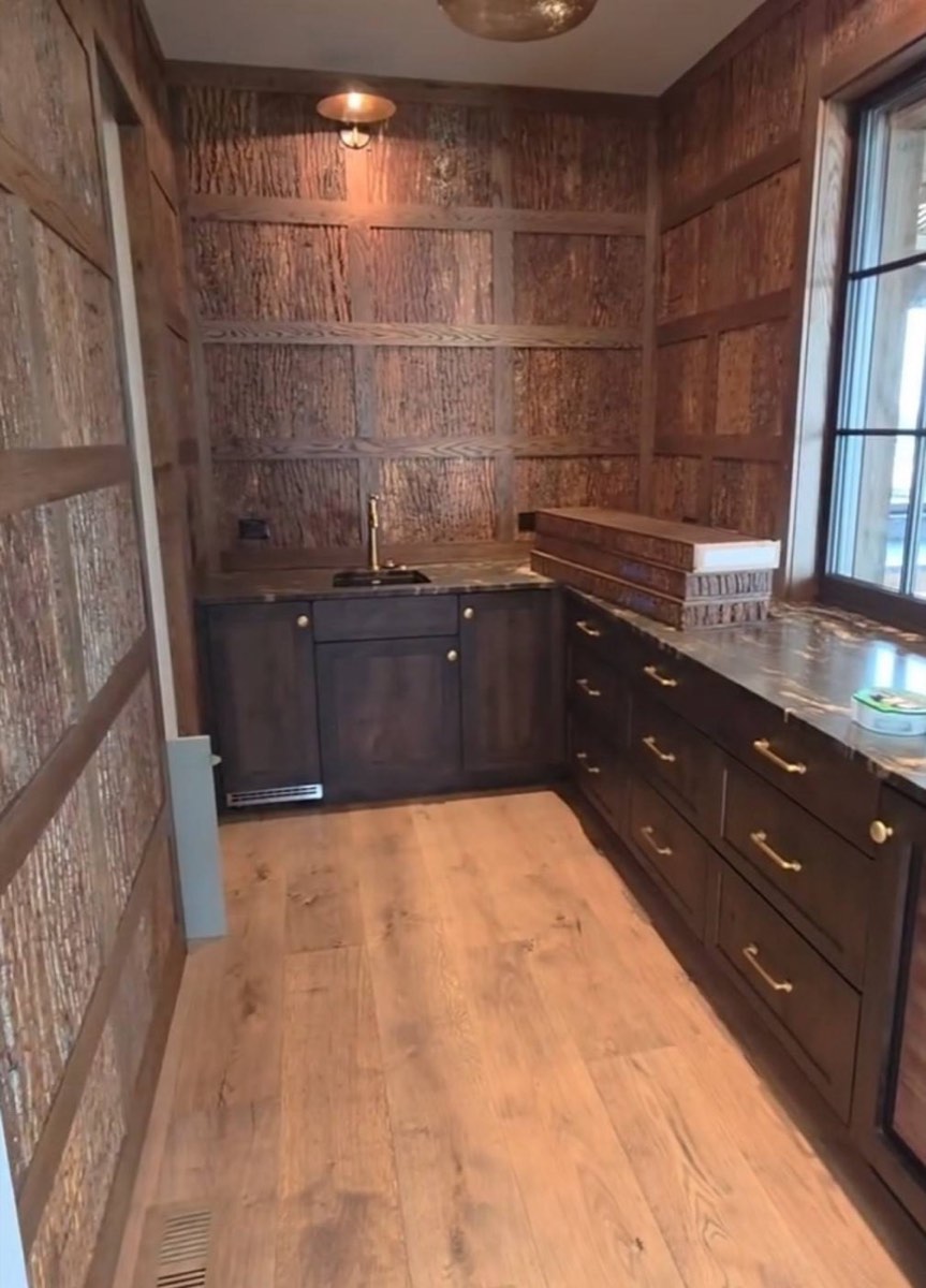 Butler's pantry full view with built-in sink, wine fridge, and bark wall panels